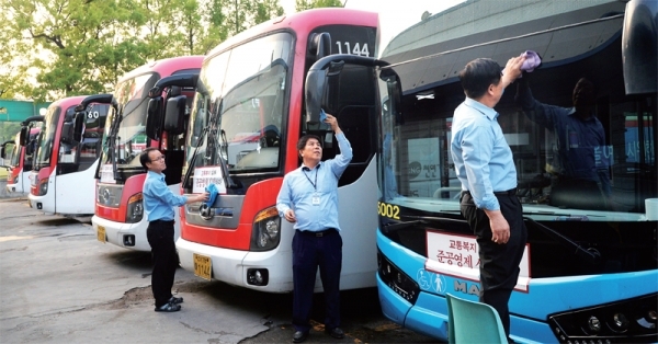 14일 오후 용인시내 한 버스차고지에서 경기도의 버스요금 인상발표 소식을 전해들은 운전자들이 한결 홀가분한 표정으로 운행을 위한 세차를 하고 있다/윤원규 기자