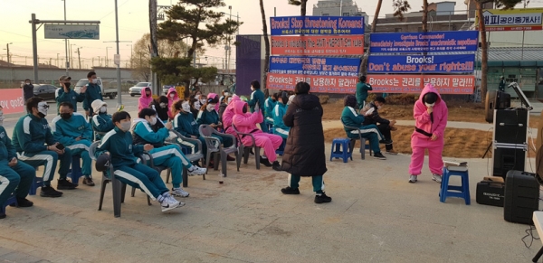 평택공인중개사 및 주택관리업체 연합회 회원들이 지난 7일 평택시 팽성읍 K-6(캠프 험프리스) 미군기지 정문 앞에서 넷플릭스 드라마 '오징어 게임'에 나온 복장을 한채 "미군 측 영업 지침서약서는 불공정한 노예계약서"라며 항의 시위를 벌이고 있다. /평택공인중개사 및 주택관리업체 연합회 제공