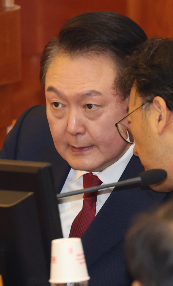 내란 우두머리(수괴) 혐의로 구속된 윤석열 대통령이 21일 오후 서울 종로구 헌법재판소에서 열린 탄핵심판 3차 변론기일에서 차기환 변호사와 대화하고 있다. /사진공동취재단
