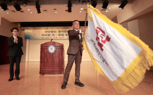 25일 경기문화재단 3층 아트홀에서 개최된 경기언론인클럽 이사장 이·취임식에서 신임 박현수 이사장이 경기언론인클럽 회사기를 흔들고 있다.